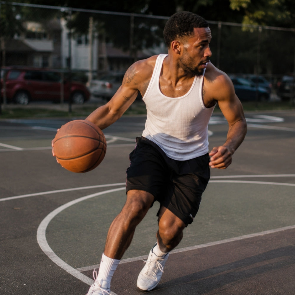 Man dribbling a basketball on an outdoor court