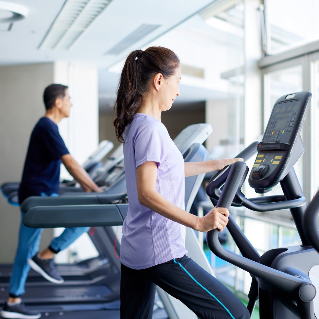 Woman exercising on a treadmill in a gym setting